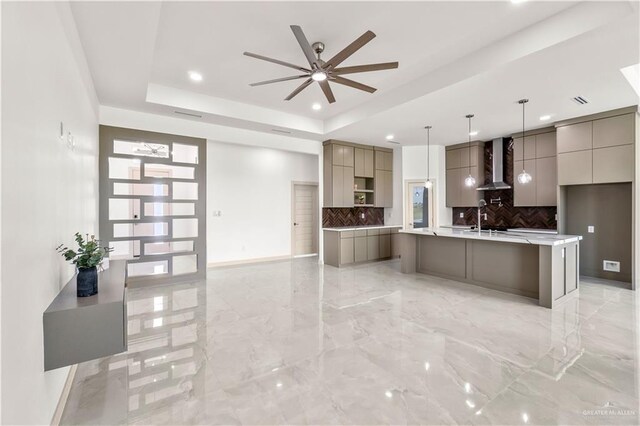 514 Oriole Dr, Los Fresnos, TX 78566 - kitchen with modern cabinets, gray cabinets, backsplash, light marble finish floors, and wall chimney range hood