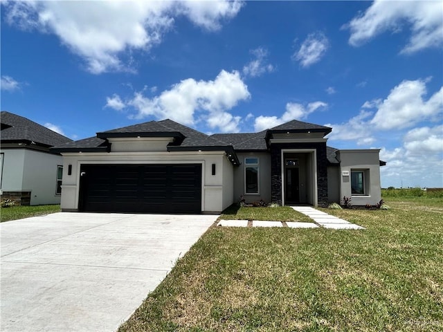 514 Oriole Dr, Los Fresnos, TX 78566 - prairie-style home with stucco siding, an attached garage, concrete driveway, a front yard, and stone siding
