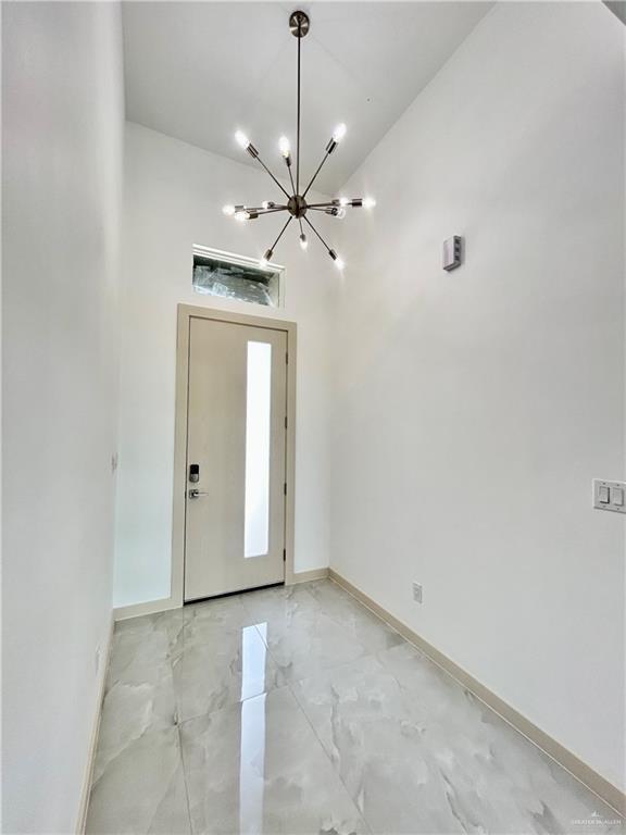 514 Oriole Dr, Los Fresnos, TX 78566 - entrance foyer featuring a chandelier and light marble finish flooring