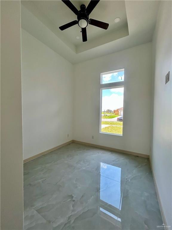 514 Oriole Dr, Los Fresnos, TX 78566 - spare room with unfinished concrete floors, ceiling fan, and a tray ceiling