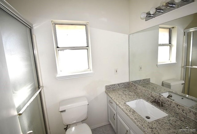 bathroom with a shower with shower door, toilet, and vanity