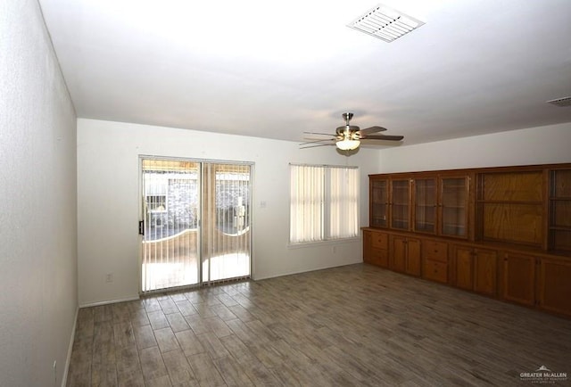 spare room featuring ceiling fan and dark hardwood / wood-style flooring