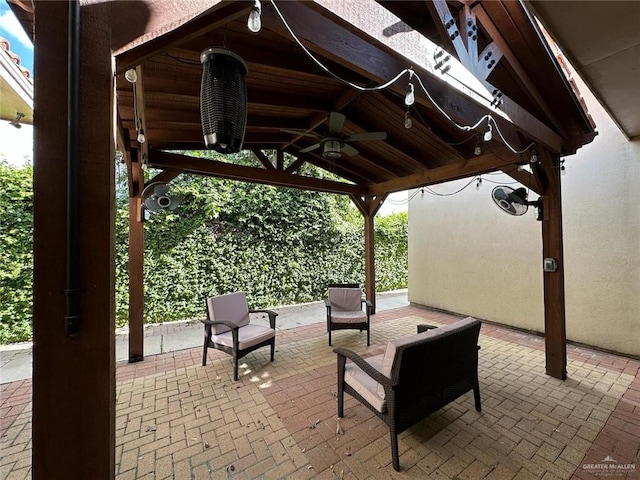 view of patio with ceiling fan and a gazebo