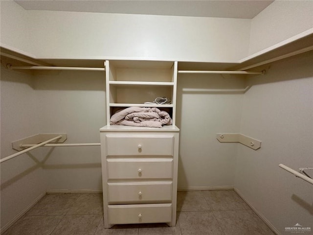 spacious closet featuring light tile patterned floors