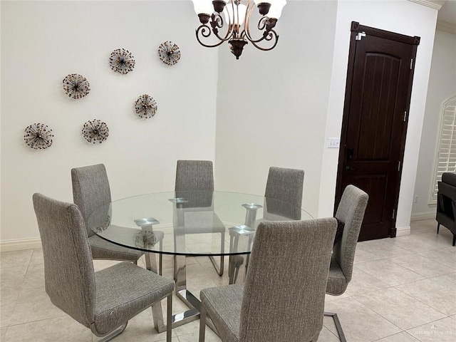dining room with light tile patterned flooring, a chandelier, and baseboards