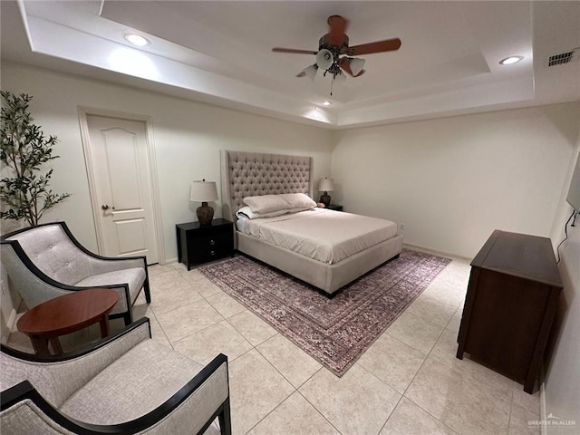 bedroom with light tile patterned floors, recessed lighting, visible vents, and a tray ceiling
