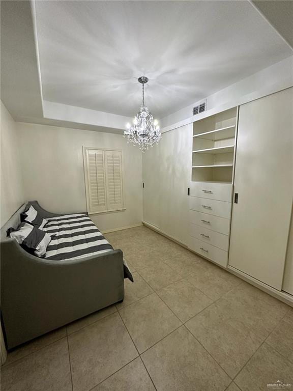 bedroom with visible vents, light tile patterned floors, and a notable chandelier