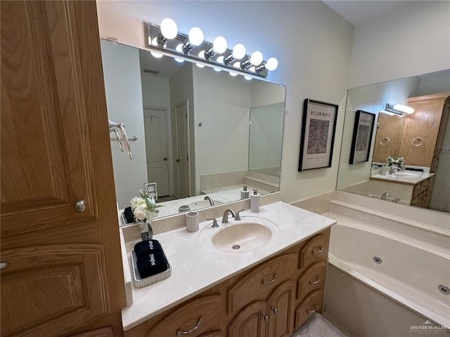 full bathroom with a whirlpool tub and vanity