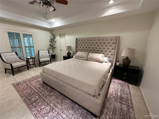 bedroom with recessed lighting, light tile patterned floors, ceiling fan, baseboards, and a raised ceiling