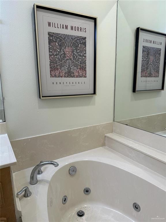 full bathroom featuring vanity and a whirlpool tub