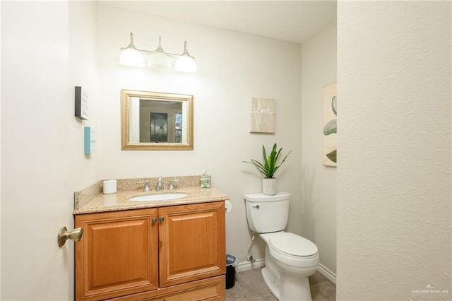 2405 E Lazy Lake Dr, Harlingen, TX 78550 - half bathroom with vanity, toilet, and tile patterned flooring