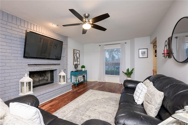 2405 E Lazy Lake Dr, Harlingen, TX 78550 - living room with ceiling fan, wood finished floors, a fireplace, and baseboards