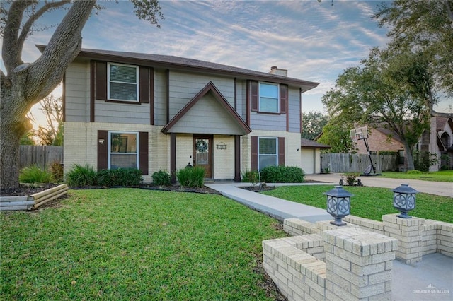 2405 E Lazy Lake Dr, Harlingen, TX 78550 - view of front facade featuring brick siding, concrete driveway, a chimney, and a garage