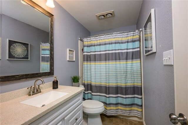 2405 E Lazy Lake Dr, Harlingen, TX 78550 - bathroom featuring vanity, toilet, a shower with curtain, and tile patterned floors