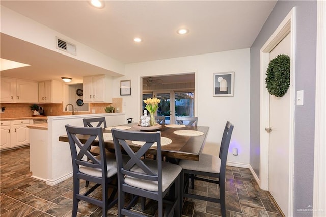 2405 E Lazy Lake Dr, Harlingen, TX 78550 - dining room featuring stone finish flooring, recessed lighting, and baseboards