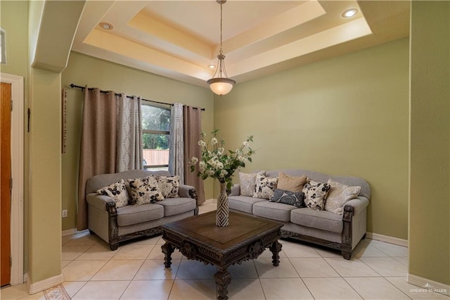 tiled living room featuring a tray ceiling