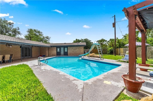 18064 Garrett Rd, Harlingen, TX 78552 - view of pool featuring a water slide, a patio area, and french doors