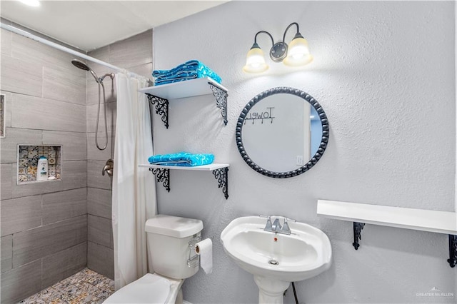 18064 Garrett Rd, Harlingen, TX 78552 - bathroom with a tile shower and toilet