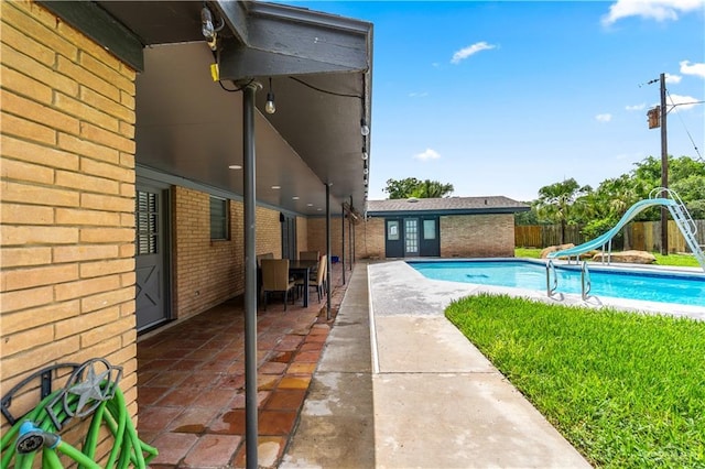 18064 Garrett Rd, Harlingen, TX 78552 - view of swimming pool with a water slide, a patio area, and outdoor dining area