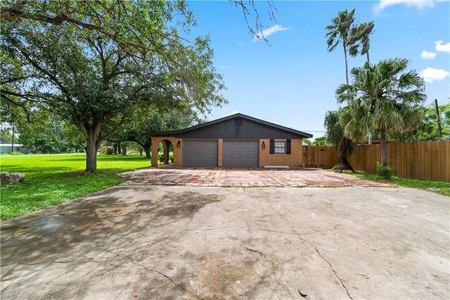 18064 Garrett Rd, Harlingen, TX 78552 - view of home's exterior featuring driveway, an attached garage, and brick siding