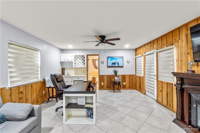 18064 Garrett Rd, Harlingen, TX 78552 - office area with wooden walls, healthy amount of natural light, a wainscoted wall, ceiling fan, and light tile patterned floors