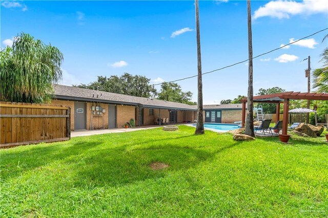 18064 Garrett Rd, Harlingen, TX 78552 - rear view of property featuring a pergola, a patio, and brick siding