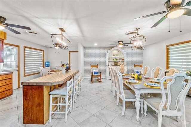 18064 Garrett Rd, Harlingen, TX 78552 - dining area featuring a ceiling fan, a chandelier, and light tile patterned flooring