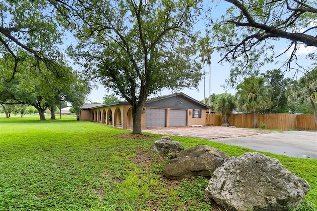 18064 Garrett Rd, Harlingen, TX 78552 - view of home's exterior featuring a garage and concrete driveway