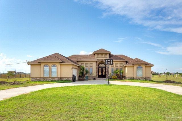 mediterranean / spanish house with a front yard and a garage