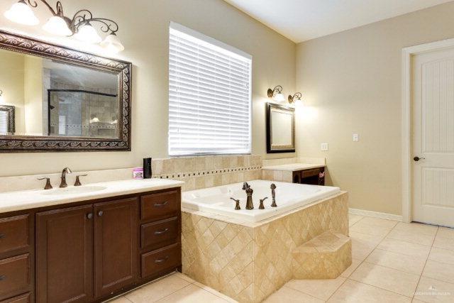 bathroom featuring tile patterned floors, separate shower and tub, and vanity