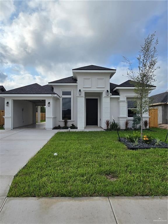 prairie-style home featuring a carport and a front lawn