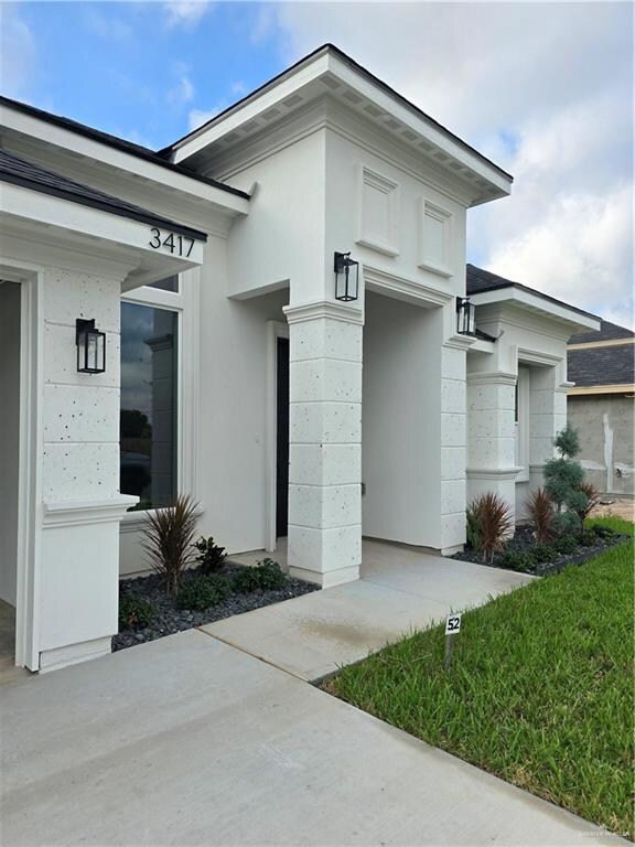 property entrance featuring a lawn