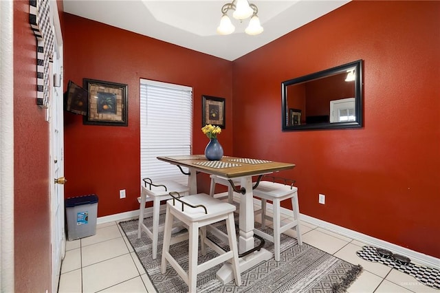 dining area featuring light tile patterned floors and a notable chandelier