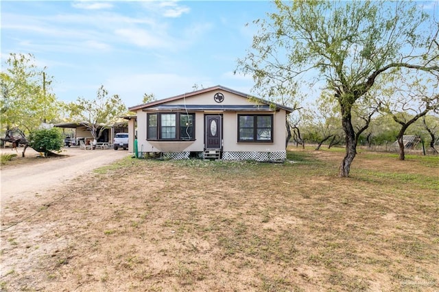 view of front facade with a front yard and a carport