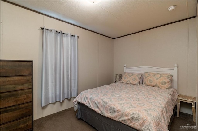 bedroom featuring crown molding, carpet floors, and a decorative wall