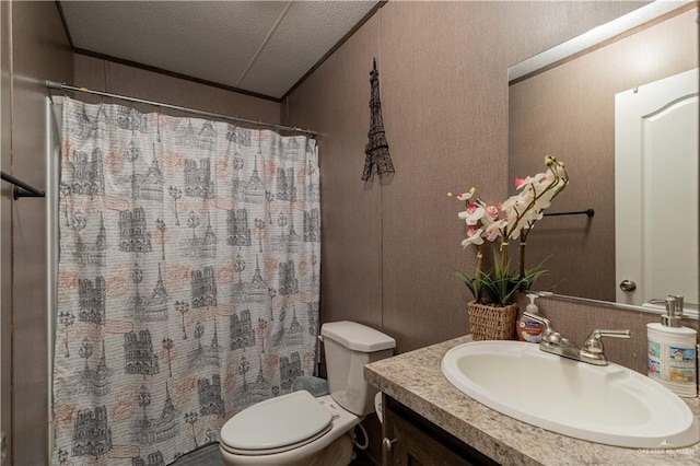bathroom with a textured ceiling, ornamental molding, toilet, curtained shower, and vanity