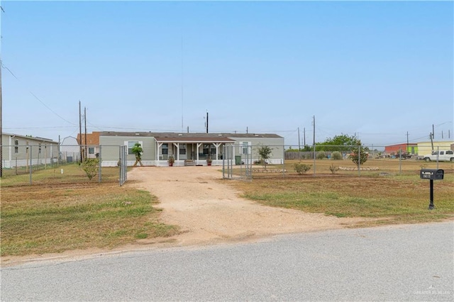 manufactured / mobile home featuring driveway and fence