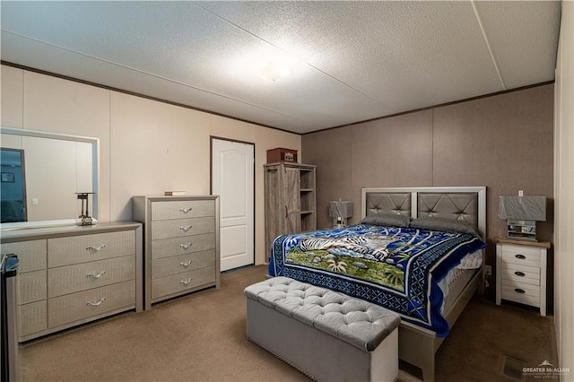 bedroom with ornamental molding, carpet, and a textured ceiling
