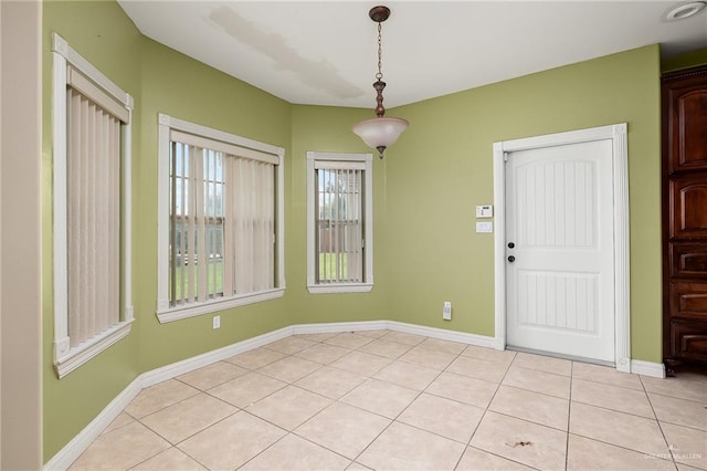 unfurnished dining area with light tile patterned floors