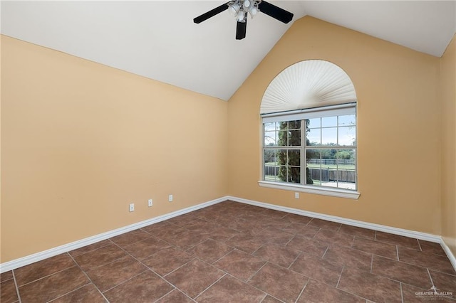 tiled spare room featuring ceiling fan and lofted ceiling