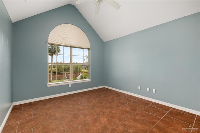 unfurnished room with dark tile patterned flooring, ceiling fan, and lofted ceiling