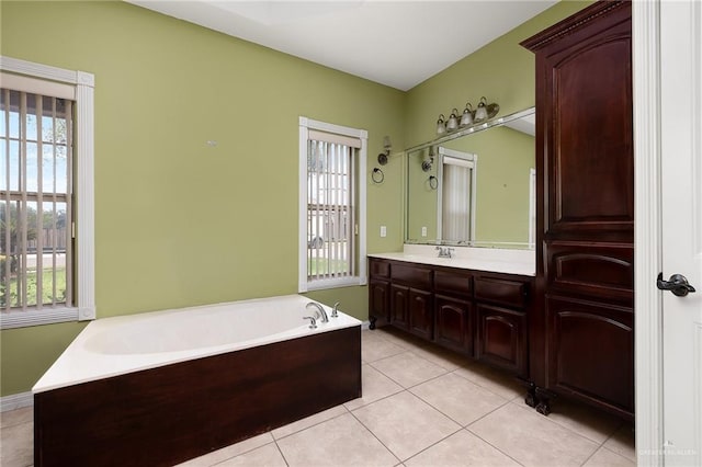 bathroom featuring tile patterned flooring, vanity, and a bathing tub