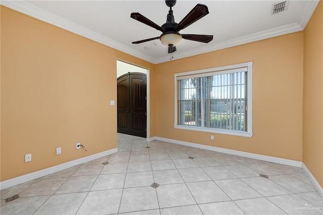 tiled empty room featuring ceiling fan and ornamental molding