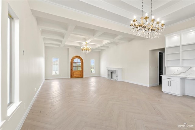 unfurnished living room with light parquet floors, an inviting chandelier, coffered ceiling, and beam ceiling