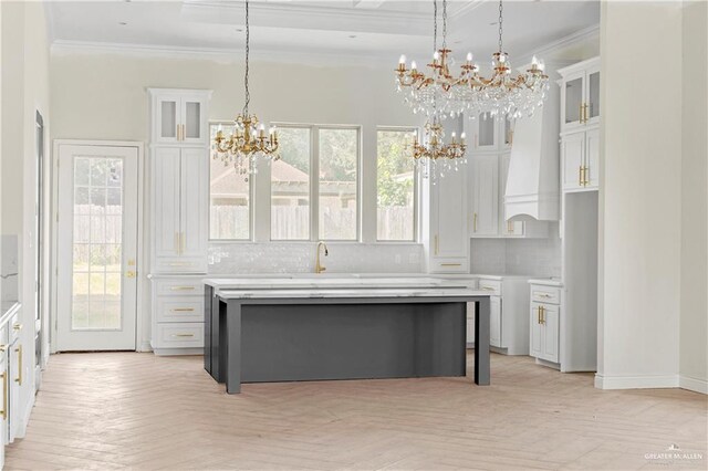 kitchen featuring white cabinets, a healthy amount of sunlight, and pendant lighting