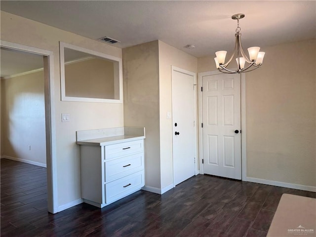 interior space featuring dark wood-type flooring and a chandelier