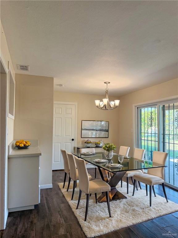 dining room featuring a chandelier and dark hardwood / wood-style floors