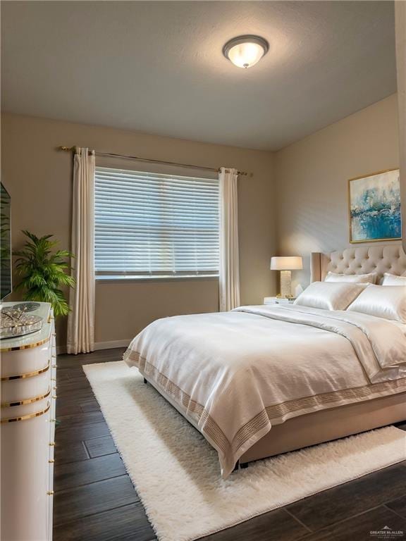 bedroom with dark hardwood / wood-style flooring