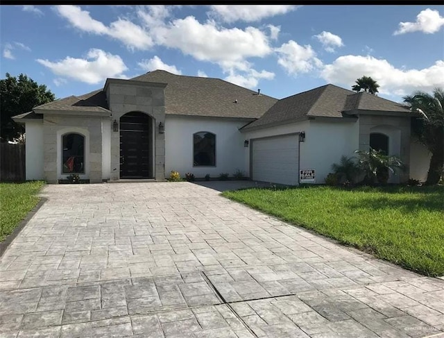 ranch-style home with a garage and a front yard