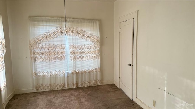 unfurnished dining area featuring carpet